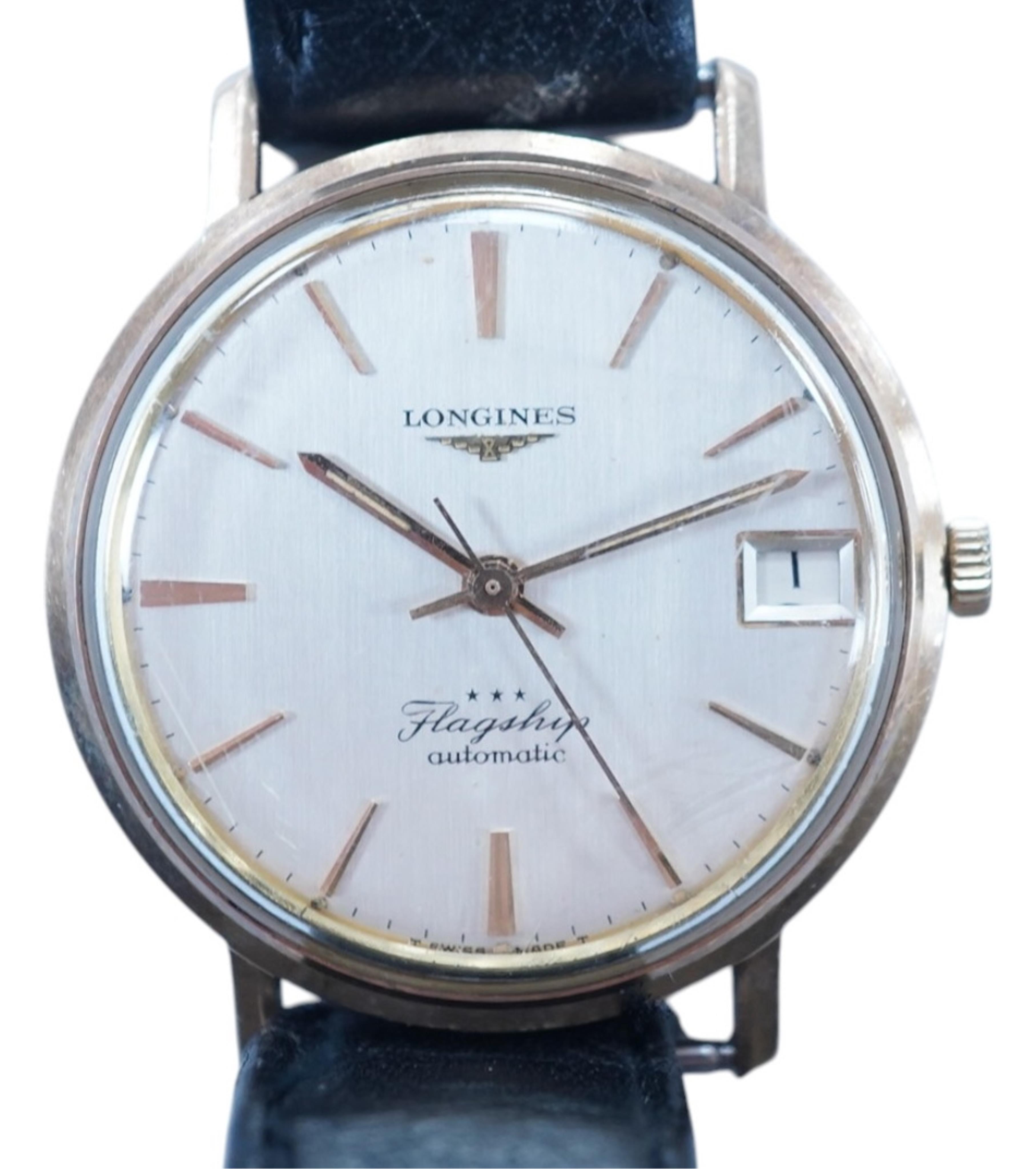 A gentleman's 9ct gold Longines Flagship automatic wrist watch, with baton numerals and date aperture, case diameter 35mm, on an associated leather strap. Condition - poor to fair